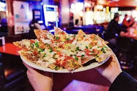 Kiki’s Restaurant and Bar signature dishes Nachos SupremeBurrito SpecialMachaca